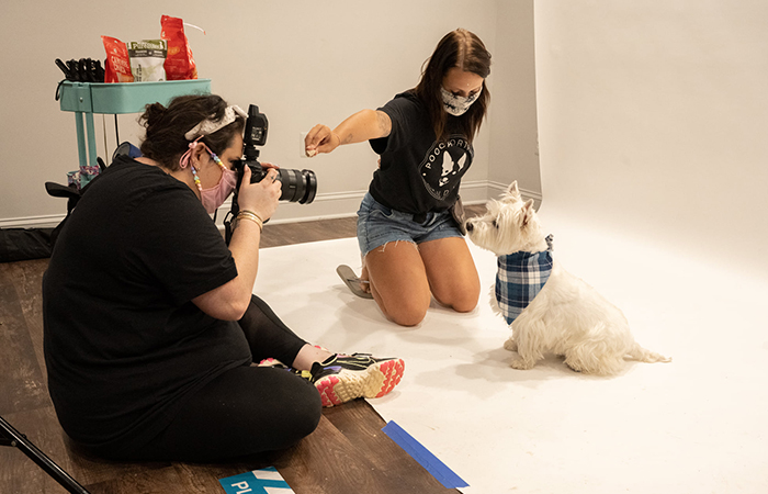 Photographer with dog in a bandana.